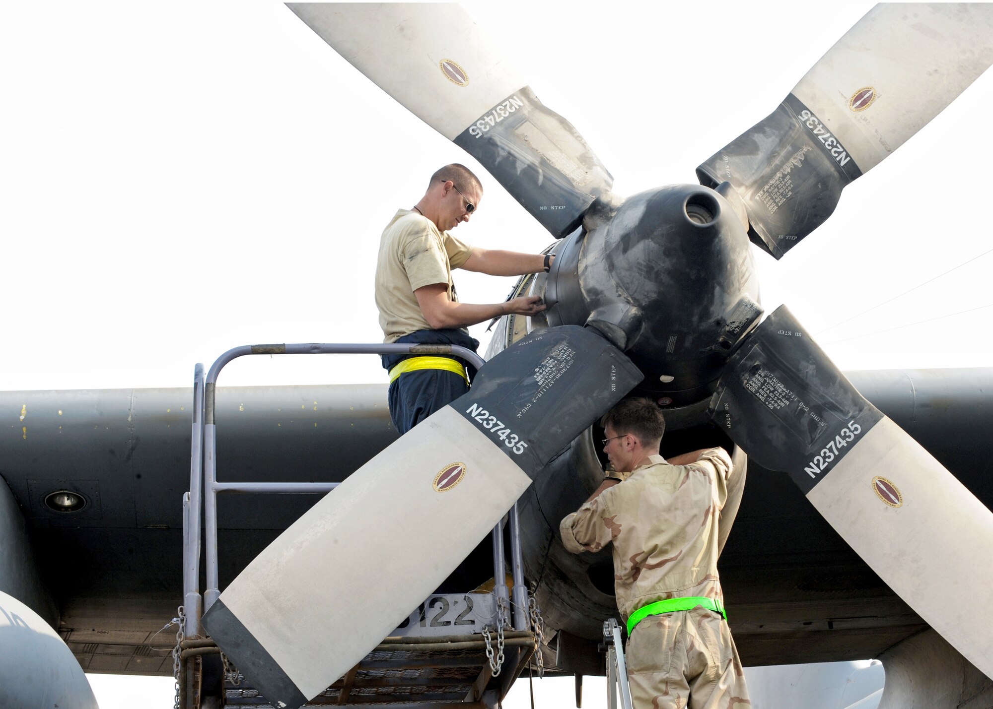 Tech. Sgt. Christopher Chadwell (left) checks the hydraulic fluid level on a C-130E propeller while Staff Sgt. William Aker inspects the engine inlet Aug. 11, 2010, at an air base in Southwest Asia. Sergeant Chadwell is an aerospace propulsion craftsman and Sergeant Aker is a flying crew chief assigned to the 386th Expeditionary Aircraft Maintenance Squadron. (U.S. Air Force photo/Senior Airman Laura Turner)