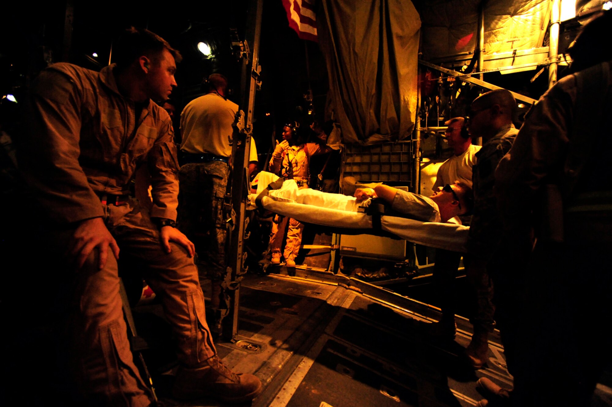 Reservists assigned to the 362nd Expeditionary Aeromedical Evacuation Flight carry on a litter patient for transport aboard a C-130 Hercules aircraft during an aeromedical mission July 17, 2010, at Tikrit, Iraq. (U.S. Air Force photo/Staff Sgt. Andy M. Kin) 