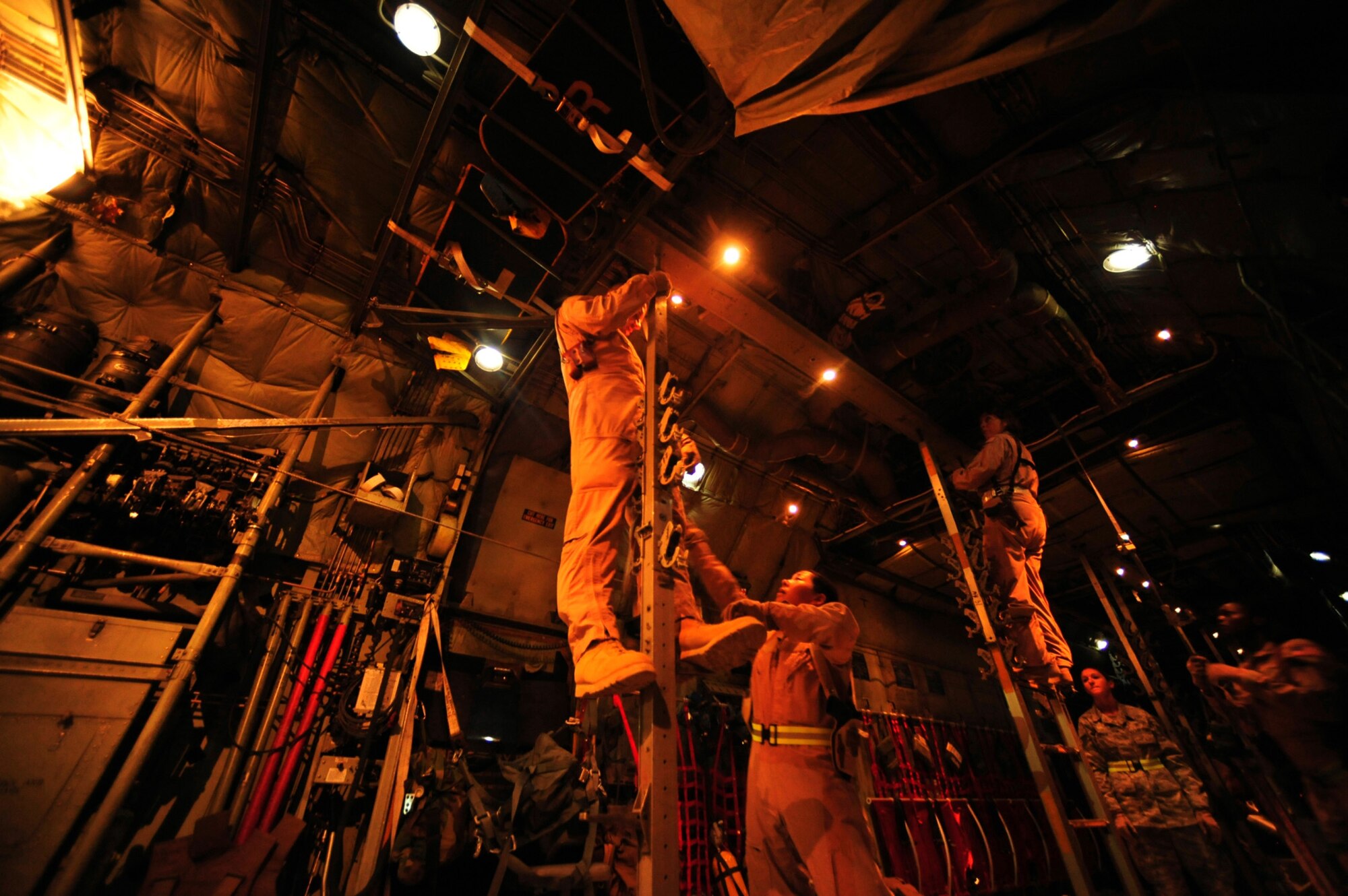 Crew members assigned to the 362nd Expeditionary Aeromedical Evacuation Flight configure a C-130 Hercules aircraft for an aeromedical evacuation mission during pre-flight inspections July 17, 2010, at Joint Base Balad, Iraq. (U.S. Air Force photo/Staff Sgt. Andy M. Kin)
