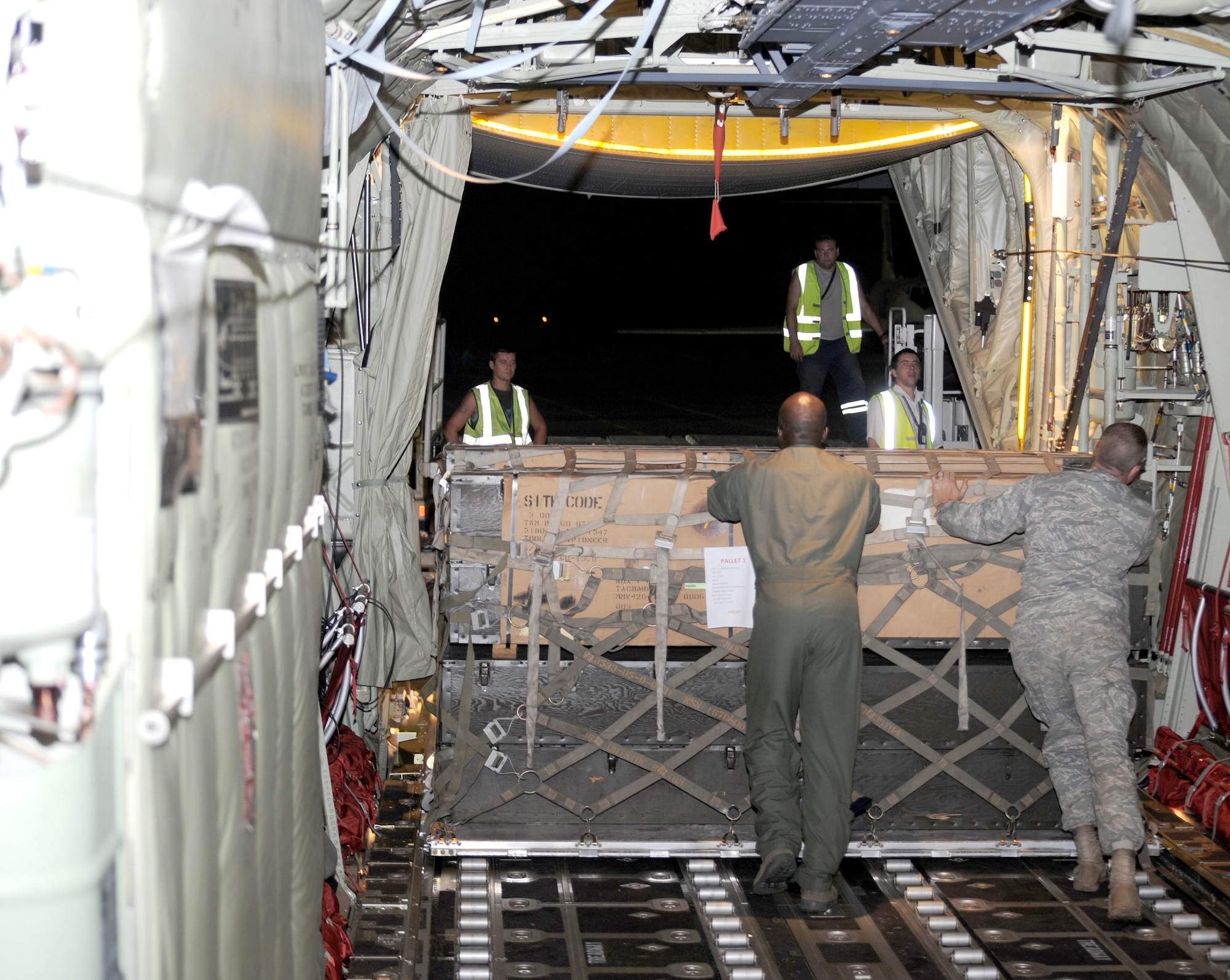 Military members download firefighting and humanitarian supplies from a C-130J Super Hercules in Moscow Aug. 14, 2010. The supplies are being delivered to Moscow after an official request from the Russian government to the U.S. and at the request of the Department of State, the Department of Defense directed U.S. European Command officials to provide valuable firefighting equipment that includes; firefighting protective equipment and tools to help Russia combat the ongoing wildfires. The military members are assigned to the 37th Airlift Squadron and U.S. Air Forces in Europe Public Affairs. (U.S. Army photo/Staff Sgt. Lawree R. Washington Jr.) 
