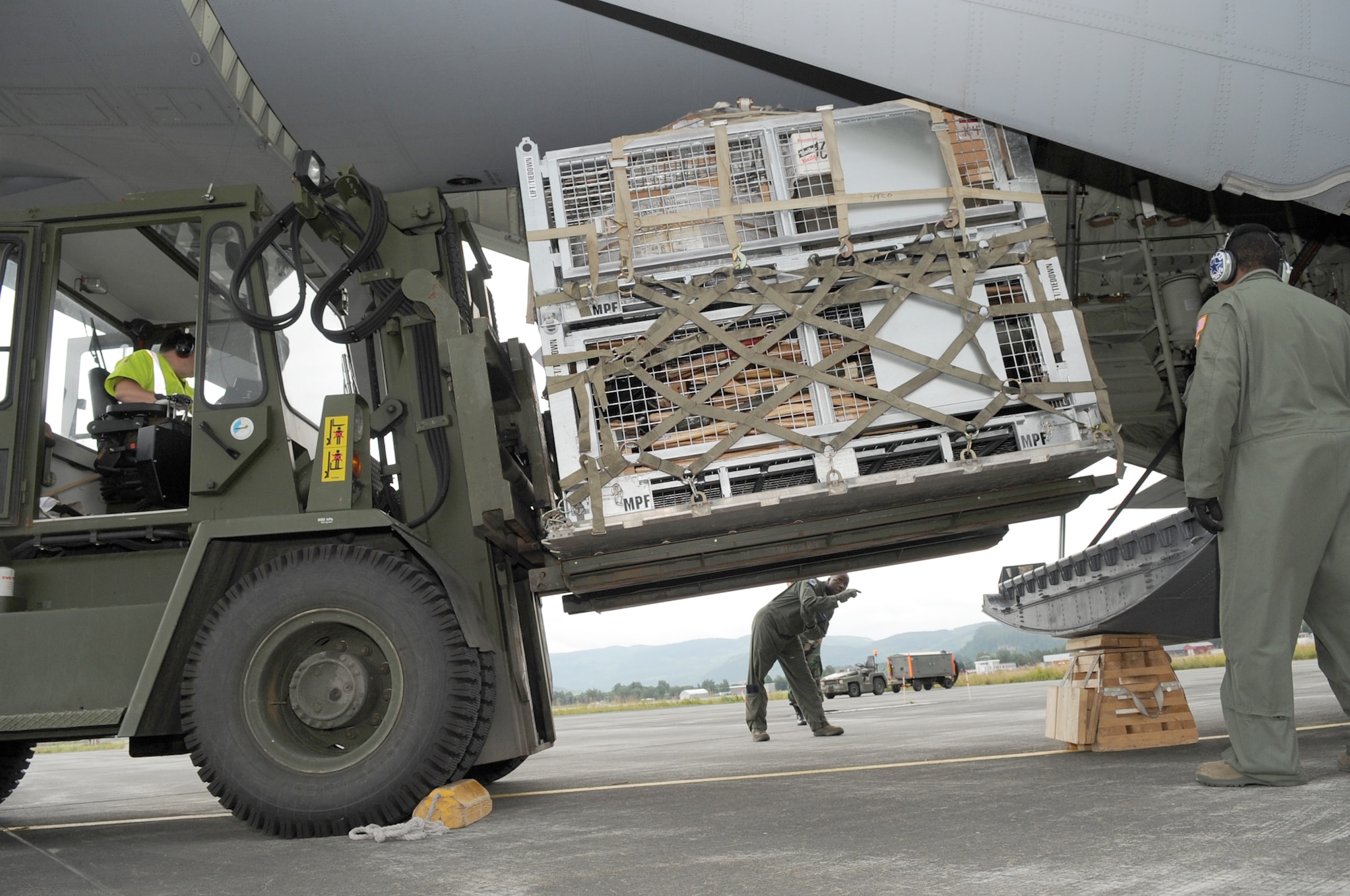 Military members load firefighting and humanitarian supplies on to a C-130J Super Hercules Aug. 14, 2010, at Trondheim Airport, Norway. The supplies are being delivered to Moscow after an official request from the Russian government to the U.S. and at the request of the Department of State, the Department of Defense directed U.S. European Command officials to provide valuable firefighting equipment that includes; firefighting protective equipment and tools to help Russia combat the ongoing wildfires. The military members are assigned to EUCOM, U.S. Air Forces in Europe, 37th Airlift Squadron and Norwegian flightline workers. (U.S. Army photo/Staff Sgt. Lawree R. Washington Jr.) 
