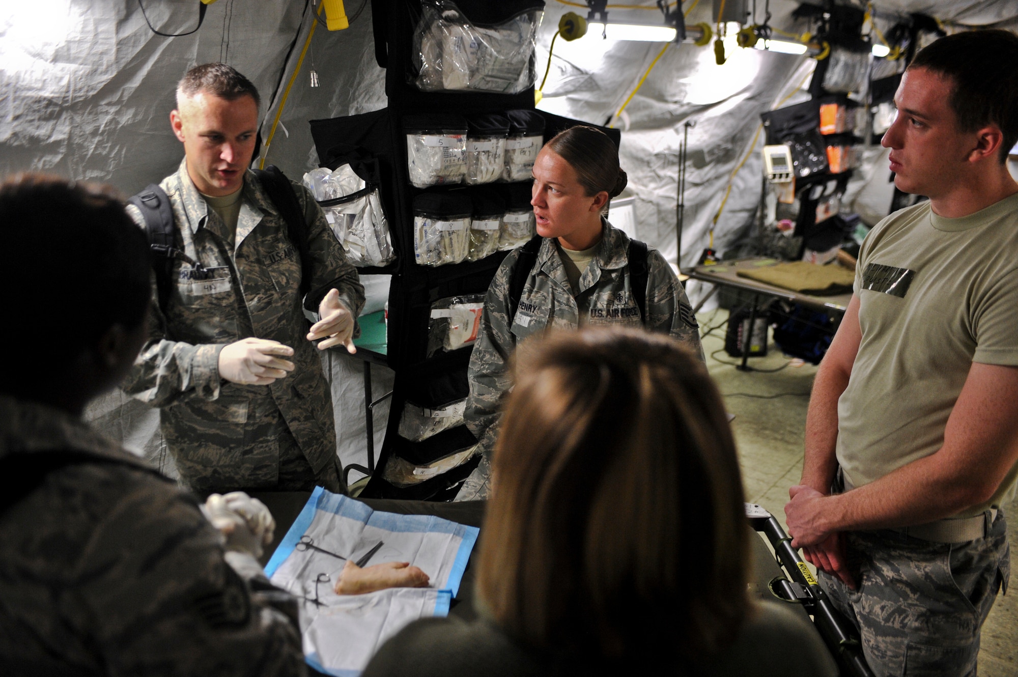 JOINT BASE ELMENDORF-RICHARDSON, Alaska – Master Sgt. Jason Bradley, 673d Medical Group, demonstrates the proper way to suture on a pig’s foot, Aug. 12. The five-day Expeditionary Medical Support Training was held for the first time at Joint Base Elmendorf-Richardson, Aug. 9-13. Eighty-one Airmen from around the Pacific Air Forces came to the mandatory pre-deployment training. The EMEDs training is typically held at Brooks City Base in San Antonio. (Air Force photo by Airman 1st Class Christopher Gross)
