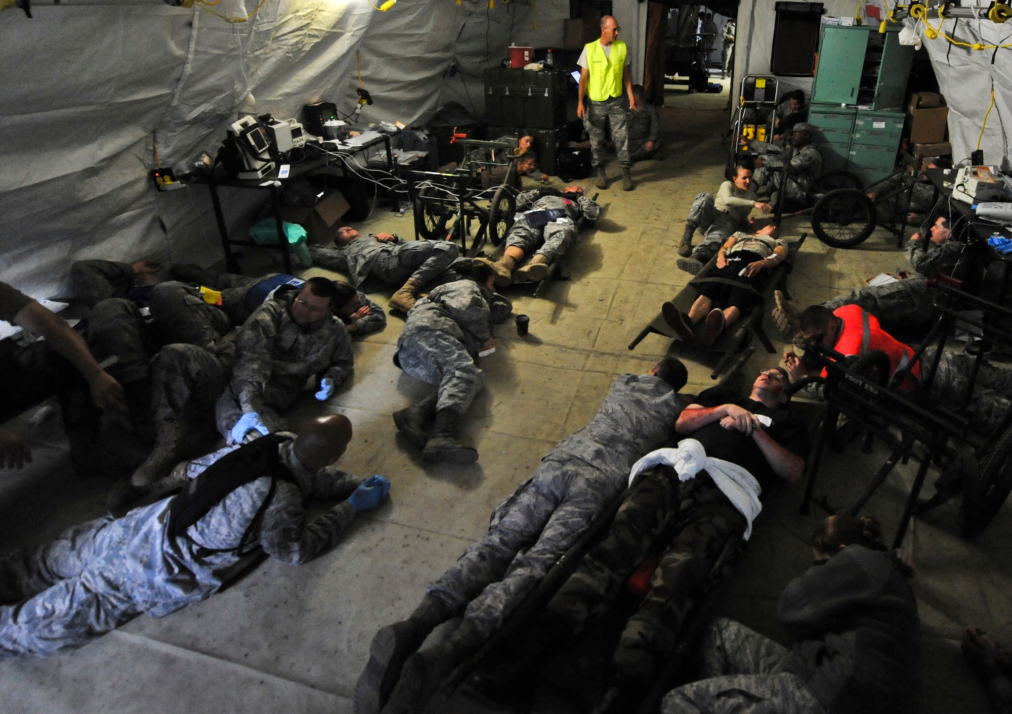 JOINT BASE ELMENDORF-RICHARDSON, Alaska – Members from the emergency room get on the floor for “cover” during “Alarm Red,” Aug. 12. The five-day Expeditionary Medical Support Training was held for the first time at Joint Base Elmendorf-Richardson, Aug. 9-13. Eighty-one Airmen from around the Pacific Air Forces came to the mandatory pre-deployment training. The EMEDs training is typically held at Brooks City Base in San Antonio. (Air Force photo by Airman 1st Class Christopher Gross)