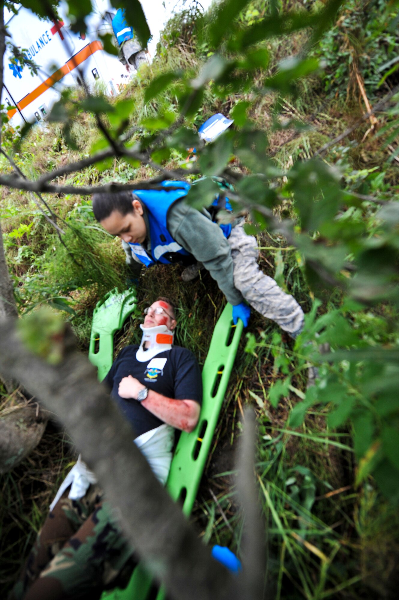 JOINT BASE ELMENDORF-RICHARDSON, Alaska – Staff Sgt. Tiffany Rewerts, 673d Medical Group, comes to the aid of a “patient” during a simulated bridge collapse scenario Aug. 12. The five-day Expeditionary Medical Support Training was held for the first time at Joint Base Elmendorf-Richardson, Aug. 9-13. Eighty-one Airmen from around the Pacific Air Forces came to the mandatory pre-deployment training. The EMEDs training is typically held at Brooks City Base in San Antonio. (Air Force photo by Airman 1st Class Christopher Gross)