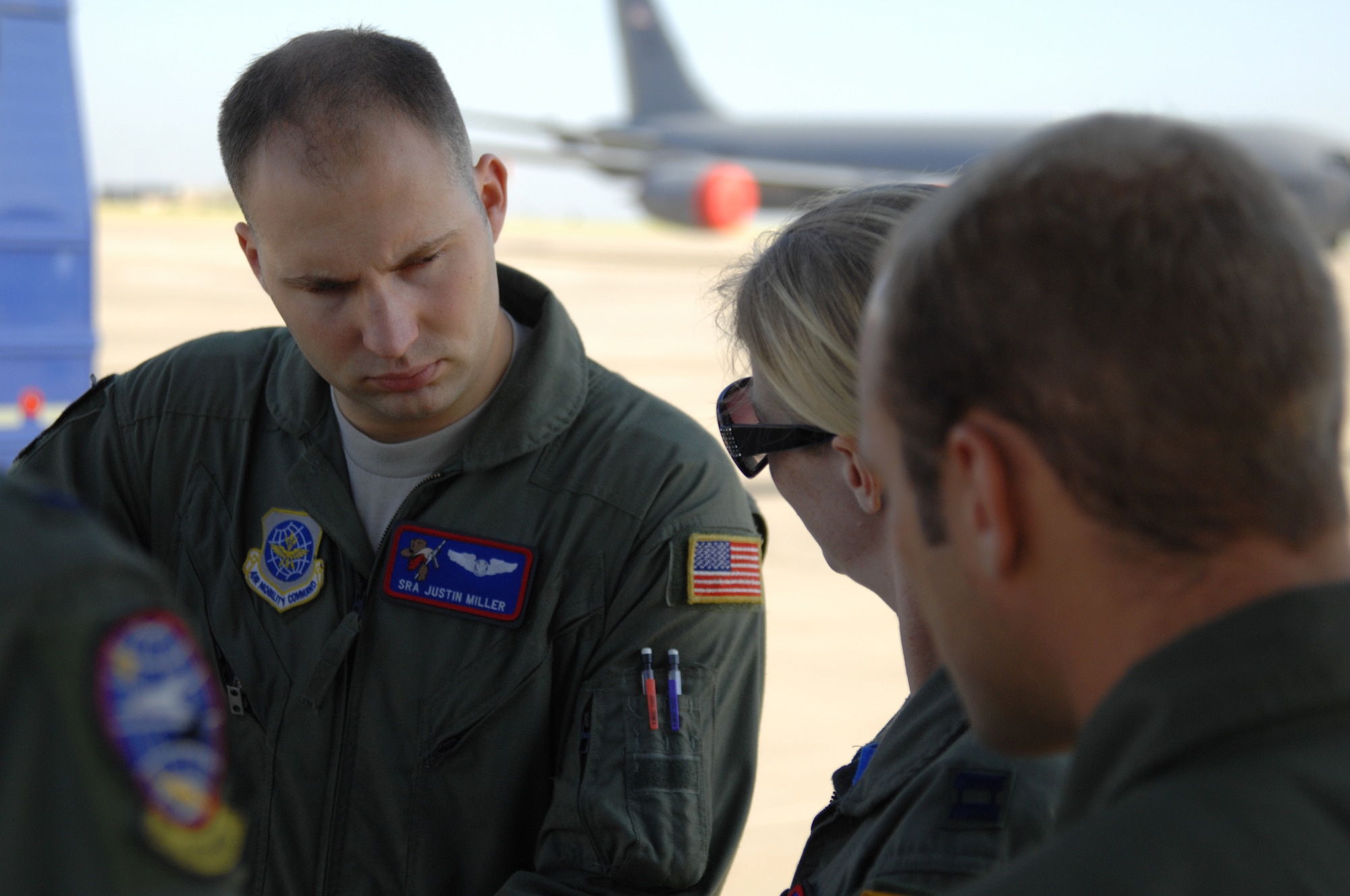 Senior Airman Justin Miller, 349th Air Refueling Squadron boom operator, listens to his pilot as the crew conducts a pre-flight inspection Aug. 13, 2010, McConnell Air Force Base, Kan. The Dayton, Ohio, native performs approximately two refueling missions a week and also performs tasks at the 349th ARS readiness office. (U.S. Air Force photo/Airman 1st Class Armando A. Schwier-Morales)