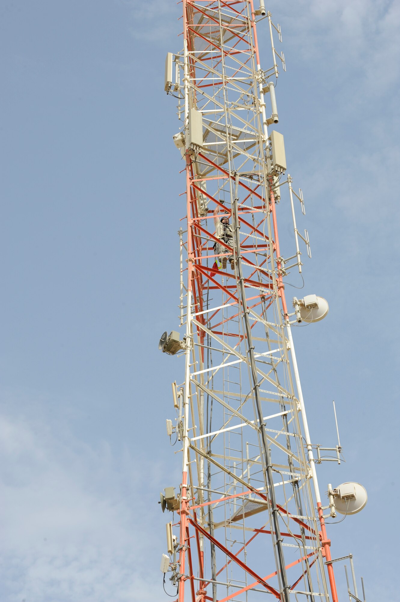 Staff Sgt. Benjamin Hawkinson, 380th Expeditionary Security Forces Squadron
Non-commissioned Officer in Charge of tactical automated security systems,
climbs the communications tower to clean a security camera Aug. 13 at an
undisclosed location in Southwest Asia. The cameras used here serve as a
vital countermeasure against ground threats by performing surveillance and
identification functions in support of security forces. (U.S. Air Force
photo/Tech. Sgt. April Wickes)



