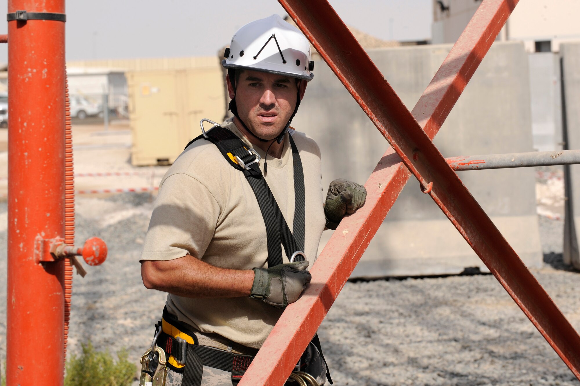 Staff Sgt. Benjamin Hawkinson, 380th Expeditionary Security Forces Squadron
Non-commissioned Officer in Charge of tactical automated security systems,
rest before climbing the communications tower to clean a security camera
Aug. 13 at an undisclosed location in Southwest Asia. The cameras used here
serve as a vital countermeasure against ground threats by performing
surveillance and identification functions in support of security forces.
(U.S. Air Force photo/Tech. Sgt. April Wickes) 


