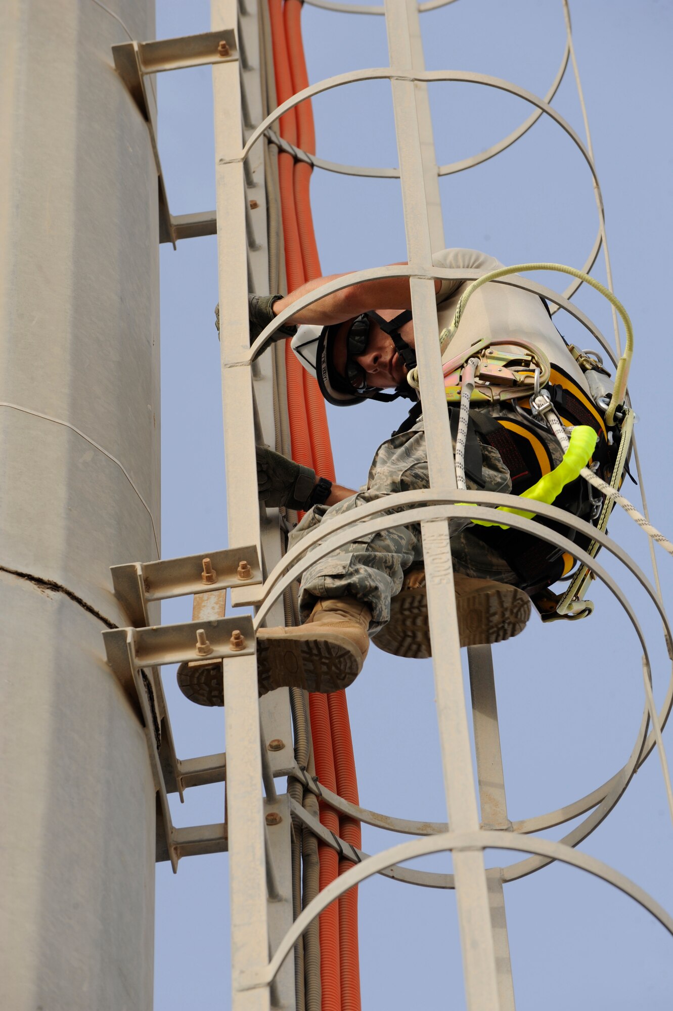 Senior Airman Samuel Williams, 380th Expeditionary Security Forces Squadron
journeyman, climbs a tower in order to clean a security camera Aug. 13 at an undisclosed location in Southwest Asia. The cameras used here serve as a vital countermeasure against ground threats by performing surveillance and identification functions in support of security forces. (U.S. Air Force photo/Tech. Sgt. April Wickes) 
