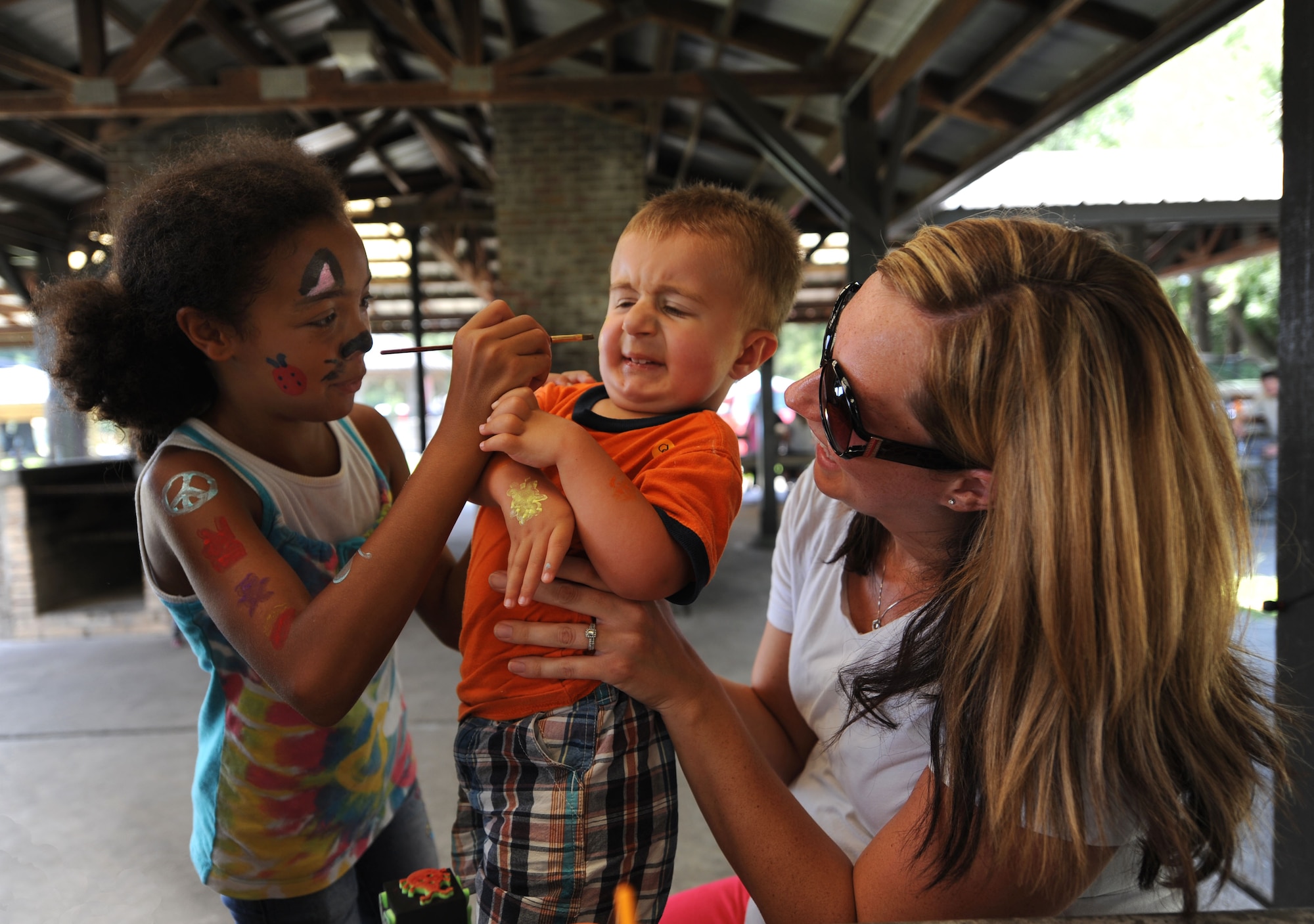 Jack Kordenbrock braces himself to get his face painted at the Exceptional Family Members Fair Aug. 13, 2010. The EFM Fair was held at the base picnic grounds to help military families with special needs children network and talk about the struggles they face on a daily basis. Jack is the son of Tiffany Kordenbrock and Airman 1st Class Nicholas Kordenbrock. (U.S. Air Force Photo/Airman 1st Class Lauren Main)
