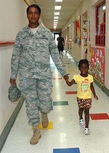 LANGLEY AIR FORCE BASE, Va. - Staff Sgt. Krystle Ward, 633d Civil Engineering Squadron SABER project manager, picks up her daughter, Kennedi, from the Child Development Center Aug. 15.  Sergeant Ward and many other active-duty parents can expect a change in their child-care rates beginning October 1. (U.S. Air Force photo/Tech. Sgt. Randy Redman)