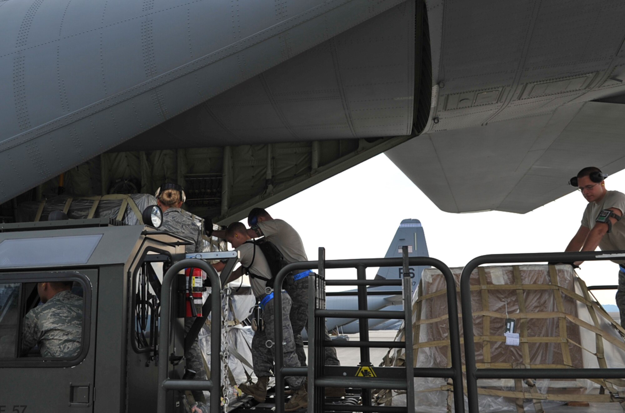 U.S. Air Force Airmen with the 721st Aerial Port Squadron load humanitarian relief cargo and equipment to an 86th Airlift Wing C-130J Super Hercules aircraft enroute to Russia, Ramstein Air Base, Germany, Aug. 13, 2010. Team Ramstein transproted fire-fighting support equipment, in cooperation with a Department of Defense initiative to help Russia combat their ongoing wildfires. ( U.S. Air Force photo by Senior Airman Tony R. Ritter )