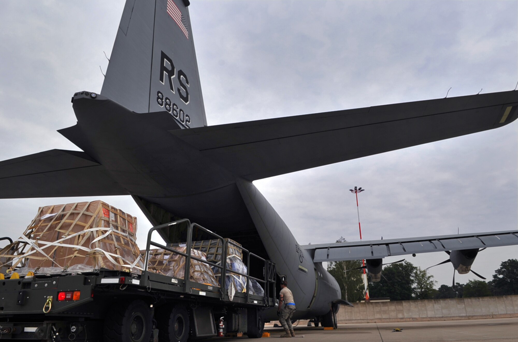 U.S. Air Force Airmen with the 721st Aerial Port Squadron load humanitarian relief cargo and equipment to an 86th Airlift Wing C-130J Super Hercules aircraft enroute to Russia, Ramstein Air Base, Germany, Aug. 13, 2010. Team Ramstein transported fire-fighting support equipment, in cooperation with a Department of Defense initiative to help Russia combat their ongoing wildfires. ( U.S. Air Force photo by Senior Airman Tony R. Ritter )