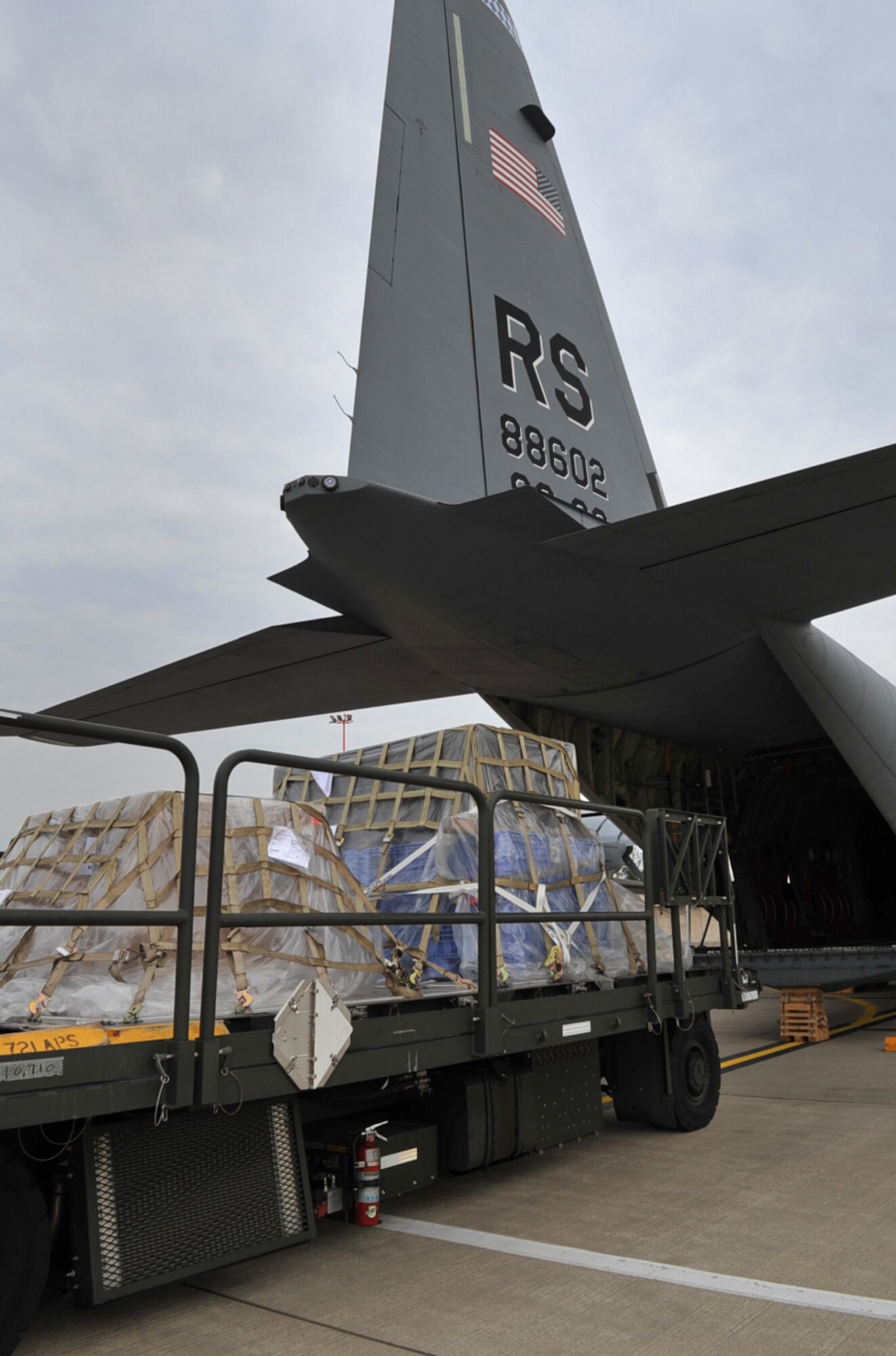 U.S. Air Force Airmen with the 721st Aerial Port Squadron load humanitarian relief cargo and equipment to an 86th Airlift Wing C-130J Super Hercules aircraft enroute to Russia, Ramstein Air Base, Germany, Aug. 13, 2010. Team Ramstein transported fire-fighting support equipment, in cooperation with a Department of Defense initiative to help Russia combat their ongoing wildfires. ( U.S. Air Force photo by Senior Airman Tony R. Ritter )