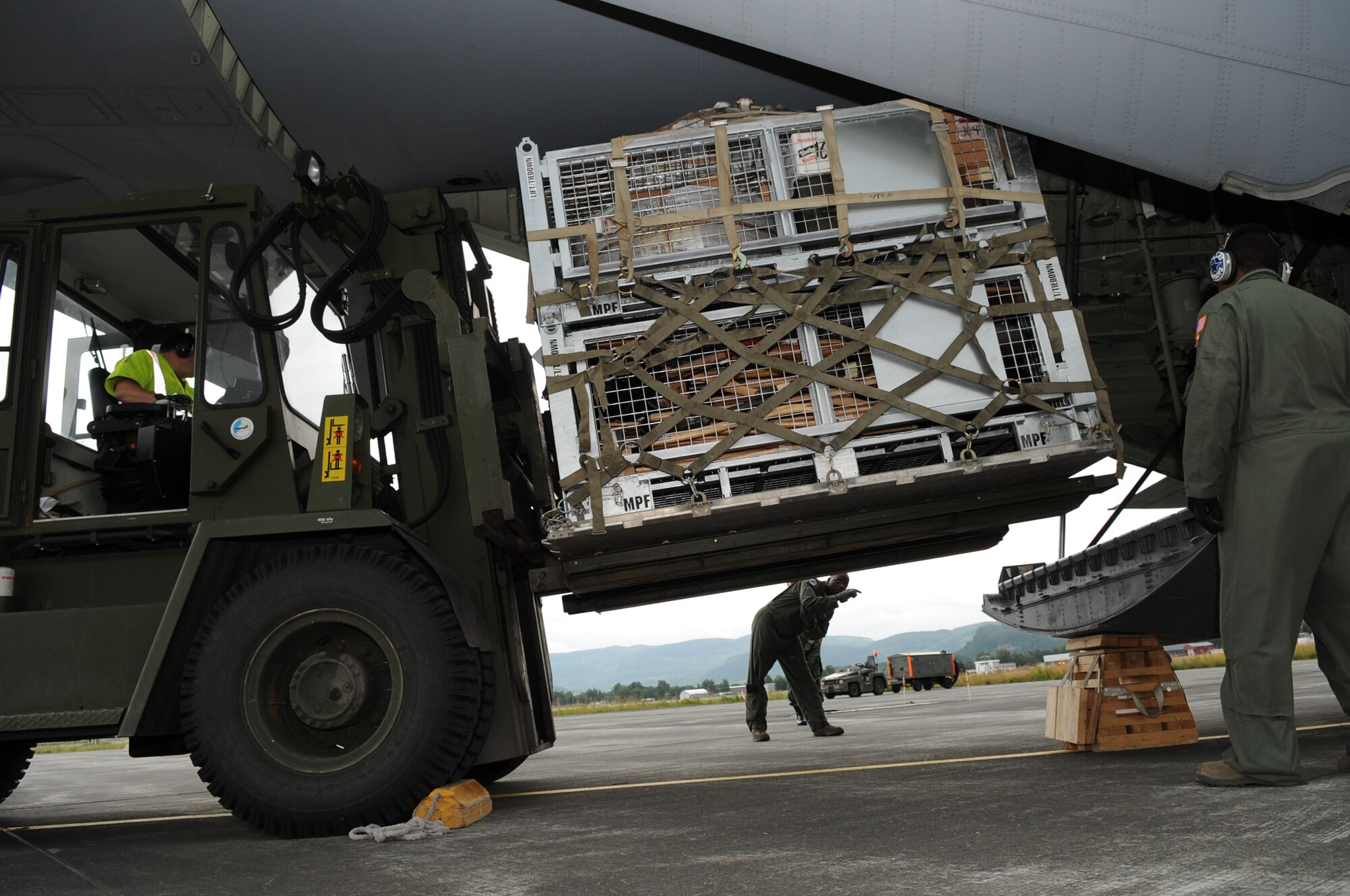 Military members from U.S. European Command, U.S. Air Forces in Europe, 37th Airlift Squadron and Norwegian flightline workers load firefighting and humanitarian supplies on to a C-130J at Trondheim Airport, Norway, Aug. 14, 2010. The supplies are being delivered to Moscow after an official request from the Russian government to the U.S. and at the request of the Department of State. The Department of Defense directed EUCOM to provide valuable firefighting equipment that includes firefighting protective equipment and tools to help Russia combat the ongoing wildfires. (U.S. Army photo by Staff Sgt. Lawree R. Washington Jr.)