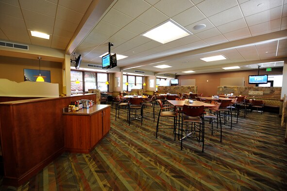 The 40-year-old Aragon dining facility on Peterson Air Force Base officially reopened Aug. 6 with a Colorado sports bar feel -- vibrant colored carpet, newly upholstered booths, high bistro-style tables and chairs and six large screen televisions -- on one side and a fine dining area on the other side, which can be closed off for special occasions or meetings. The $1.8 million renovation project included an overhaul of the restrooms, a handicap accessible entry way and a new heating, ventilating and air conditioning unit. (U.S. Air Force photo/Rob Bussard)