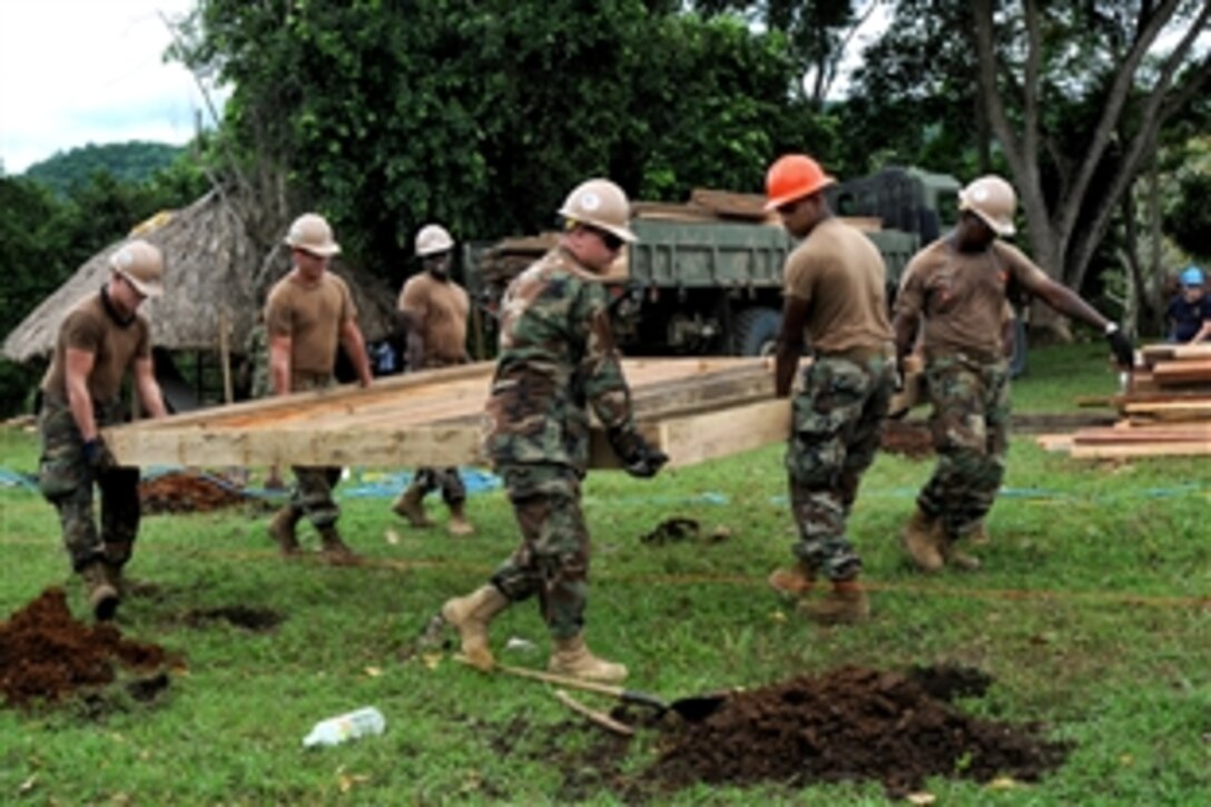 U.S. Navy Seabees assigned to Naval Mobile Construction Battalion 7 and Construction Battalion Mobile Unit 202 move a floor base during a Continuing Promise construction project at a school in Don Gabriel, Colombia, Aug. 13, 2010. 