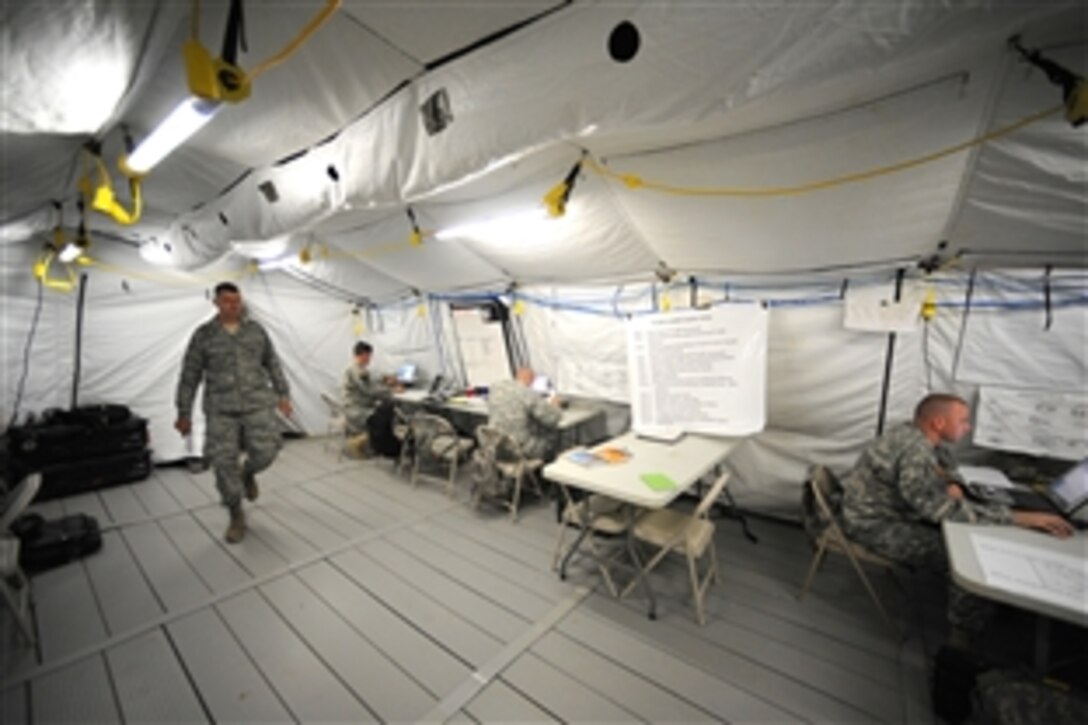 Servicemembers work in the tactical operations center that houses Task Force Operations whose mission is to deploy and establish a brigade task force at a designated location within the U.S. Northern Command Joint Operations Area on Fort Leavenworth, Kan., Aug. 14, 2010. These efforts are in support of Vibrant Response Command Post Exercise 11.1