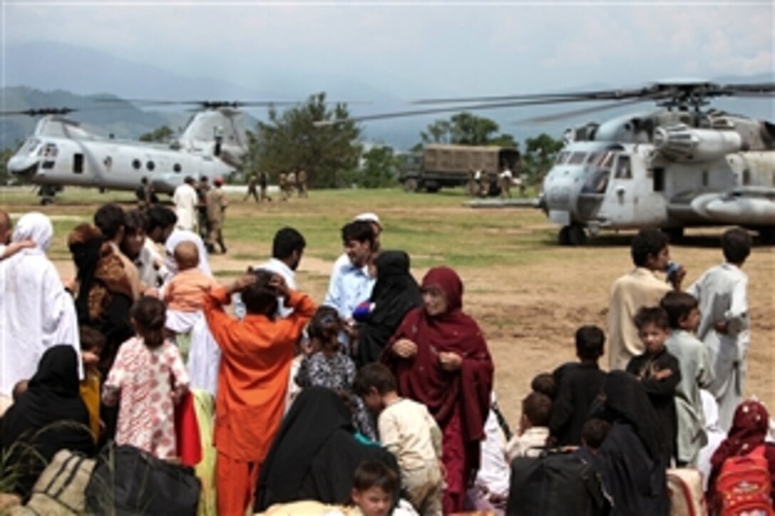 Pakistani flood victims await transportation aboard helicopters attached 15th Marine Expeditionary Unit, during humanitarian relief efforts in the Khyber-Pakhtunkhwa province, Pakistan, Aug. 17, 2010.