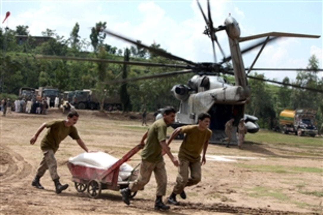 Pakistani soldiers load supplies onto U.S. Marine CH-53E Super Stallion helicopters attached to the HM-165, 15th Marine Expeditionary Unit, during humanitarian relief efforts in the Khyber-Pakhtunkhwa province, Pakistan, Aug. 17, 2010.