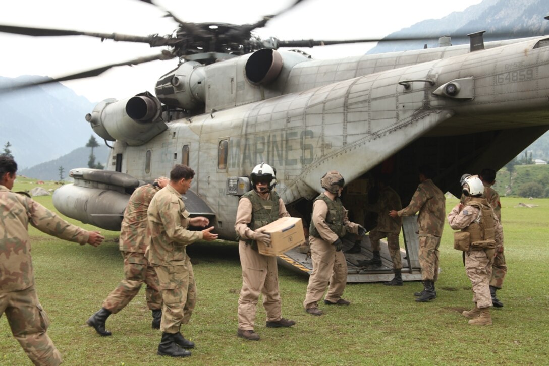 Marines from HMM-165 (REIN), 15th MEU and Pakistani Soldiers unload supplies from Marine Super Stallion helicopters during humanitarian relief efforts in the Khyber-Pakhtunkhwa province, Pakistan (formerly known as the Northwest Frontier province).