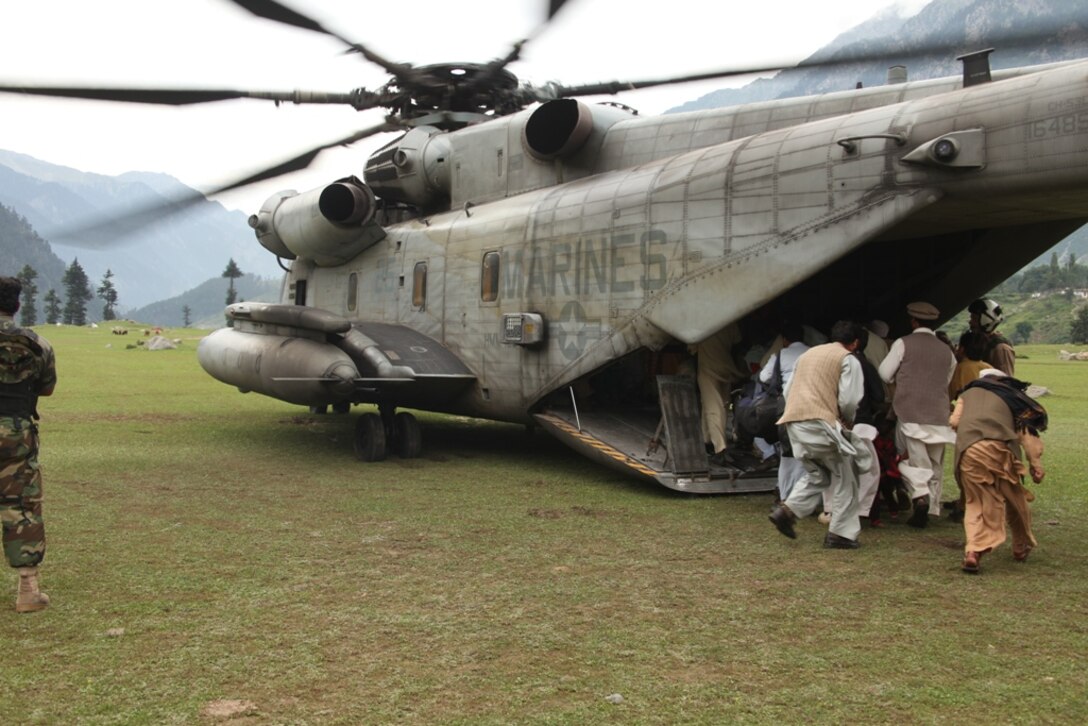 Pakistani citizens board Marine Super Stallion (CH-53E) helicopters from HMM-165 (REIN), 15th MEU during humanitarian relief efforts in the Khyber-Pakhtunkhwa province, Pakistan (formerly known as the Northwest Frontier province, Pakistan).