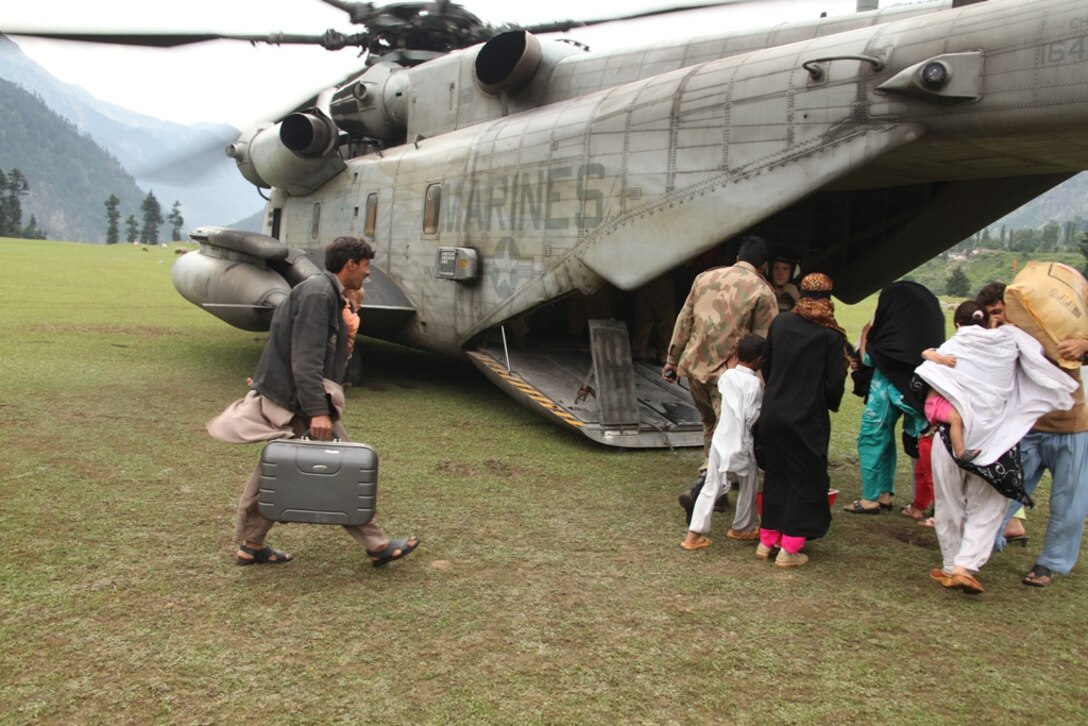 Pakistani citizens board Marine Super Stallion (CH-53E) helicopters from HMM-165 (REIN), 15th MEU during humanitarian relief efforts in the Khyber-Pakhtunkhwa province, Pakistan (formerly known as the Northwest Frontier province, Pakistan).