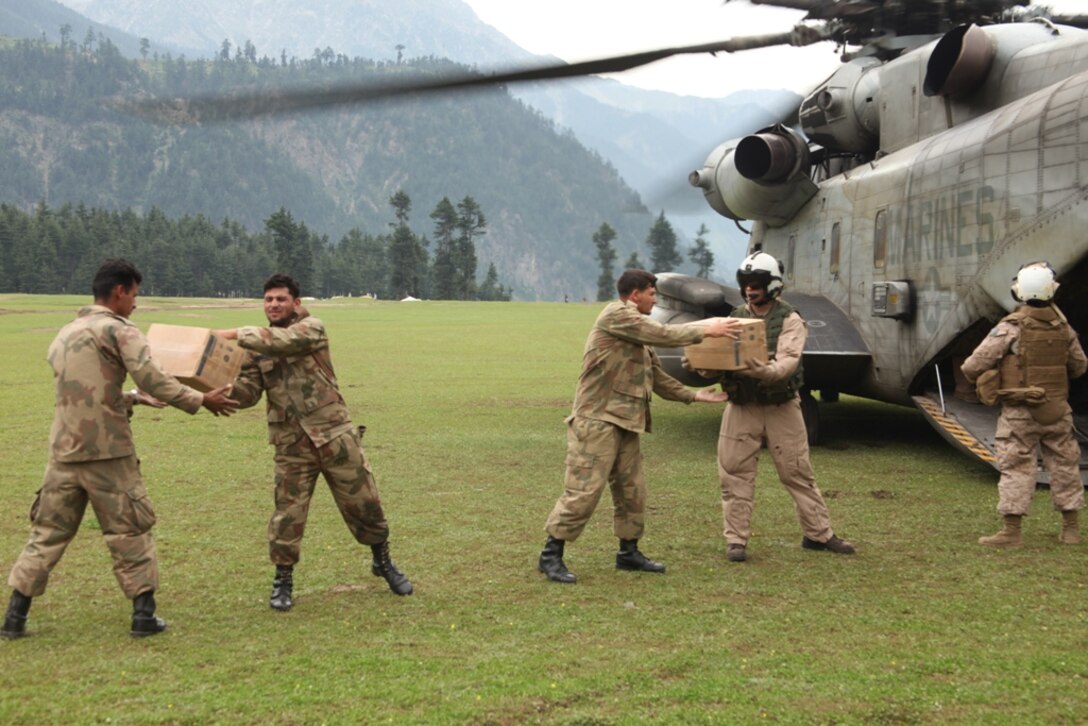 Marines from HMM-165 (REIN), 15th MEU and Pakistani Soldiers unload supplies from Marine Super Stallion helicopters during humanitarian relief efforts in the Khyber-Pakhtunkhwa province, Pakistan (formerly known as the Northwest Frontier province).