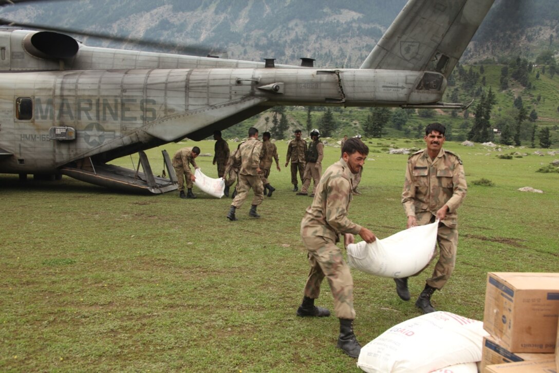 Pakistani Soldiers unload supplies from Marine Super Stallion helicopters during humanitarian relief efforts in the Khyber-Pakhtunkhwa province, Pakistan (formerly known as the Northwest Frontier province).