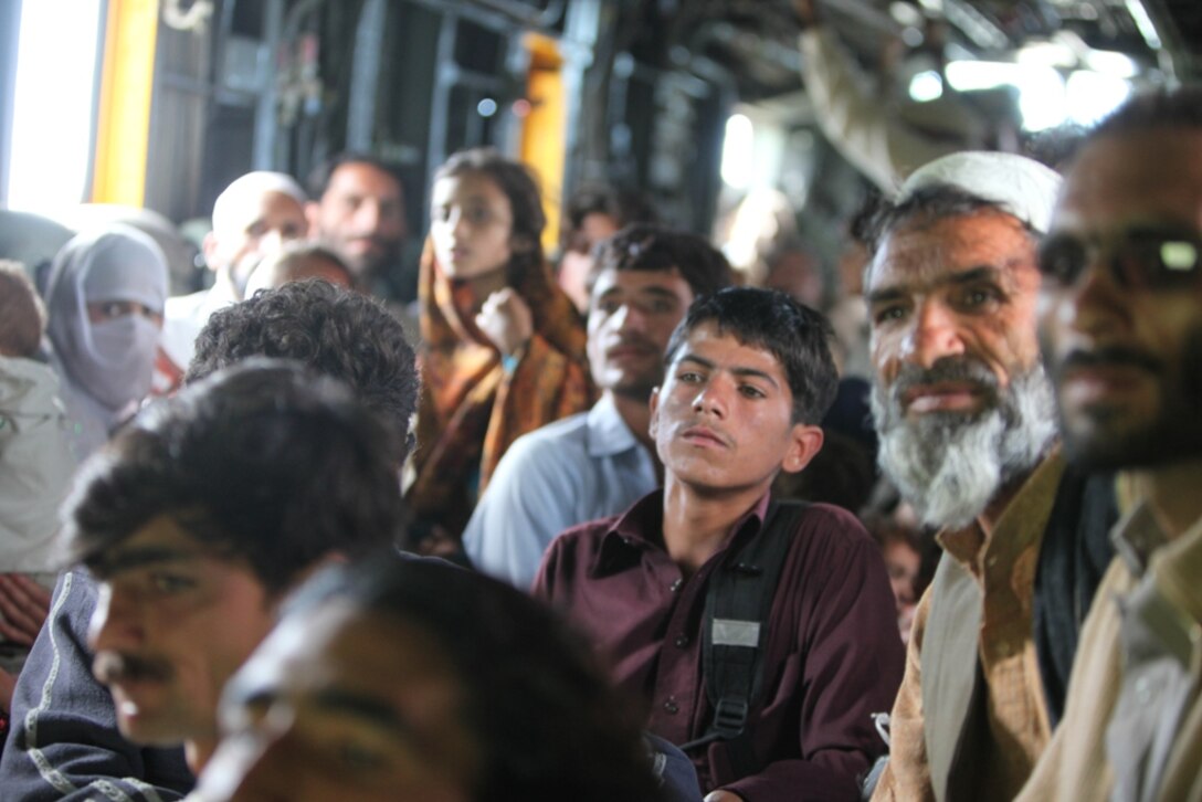 Pakistani flood victims take flight aboard Marine Super Stallion (CH-53E) helicopter attached to the HM-165 (REIN), 15th MEU during humanitarian relief efforts in the Khyber-Pakhtunkhwa province, Pakistan (formerly known as the Northwest Frontier province, Pakistan).