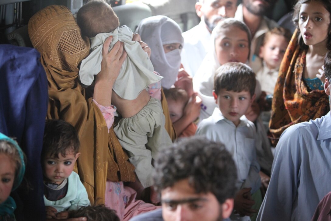 Pakistani flood victims take flight aboard Marine Super Stallion (CH-53E) helicopter attached to the HM-165 (REIN), 15th MEU during humanitarian relief efforts in the Khyber-Pakhtunkhwa province, Pakistan (formerly known as the Northwest Frontier province, Pakistan).