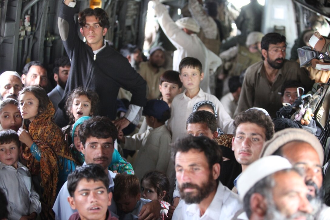 Pakistani flood victims take flight aboard Marine Super Stallion (CH-53E) helicopter attached to the HM-165 (REIN), 15th MEU during humanitarian relief efforts in the Khyber-Pakhtunkhwa province, Pakistan (formerly known as the Northwest Frontier province, Pakistan).