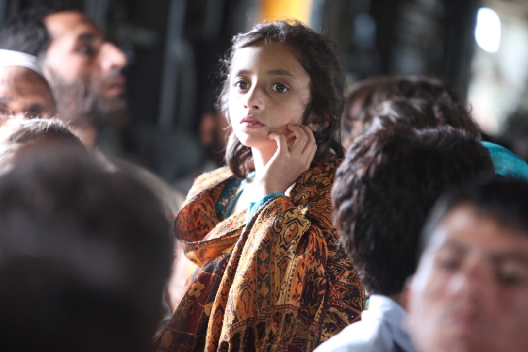 Young Pakistani flood victim takes flight aboard Marine Super Stallion (CH-53E) helicopter attached to the HM-165 (REIN), 15th MEU during humanitarian relief efforts in the Khyber-Pakhtunkhwa province, Pakistan (formerly known as the Northwest Frontier province, Pakistan).