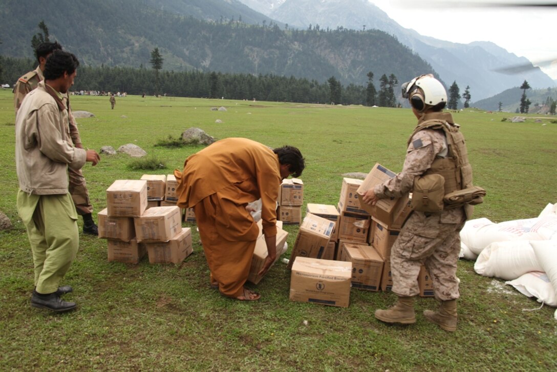 Marines from HMM-165 (REIN), 15th MEU and Pakistani Soldiers unload supplies from Marine Super Stallion helicopters during humanitarian relief efforts in the Khyber-Pakhtunkhwa province, Pakistan (formerly known as the Northwest Frontier province).