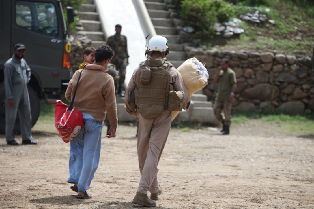 15th MEU Marine assist Pakistani flood victim move personal goods during humanitarian relief efforts in the Khyber-Pakhtunkhwa province, Pakistan (formerly known as the Northwest Frontier province, Pakistan).