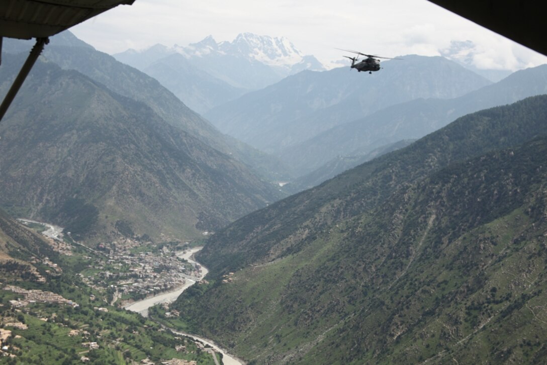Navy Sea Dragon (MH-53E) helicopter attached to the HMM-165 (REIN), 15th MEU navigates the countryside of Kalam Valley during humanitarian relief efforts in the Khyber-Pakhtunkhwa province, Pakistan (formerly known as the Northwest Frontier province, Pakistan).