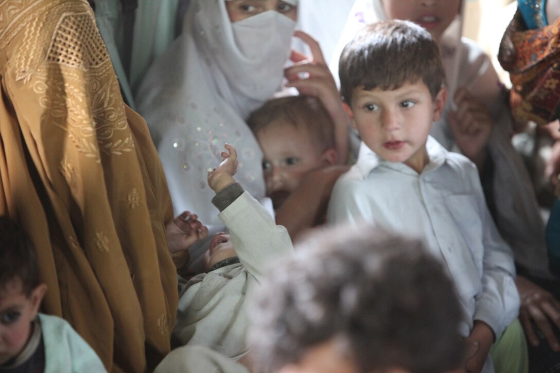 Young Pakistani flood victims take flight aboard Marine Super Stallion (CH-53E) helicopter attached to the HM-165 (REIN), 15th MEU during humanitarian relief efforts in the Khyber-Pakhtunkhwa province, Pakistan (formerly known as the Northwest Frontier province, Pakistan).