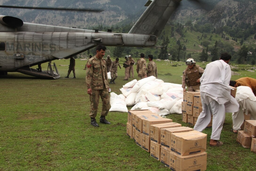 Marines from HMM-165 (REIN), 15th MEU and Pakistani Soldiers unload supplies from Marine Super Stallion helicopters during humanitarian relief efforts in the Khyber-Pakhtunkhwa province, Pakistan (formerly known as the Northwest Frontier province).