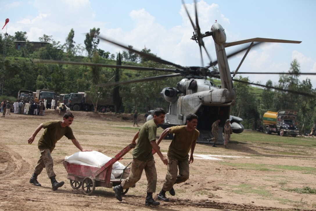 Pakistani soldiers load supplies onto Marine Super Stallion (CH-53E) helicopters attached to the HM-165 (REIN), 15th MEU during humanitarian relief efforts in the Khyber-Pakhtunkhwa province, Pakistan (formerly known as the Northwest Frontier province, Pakistan).