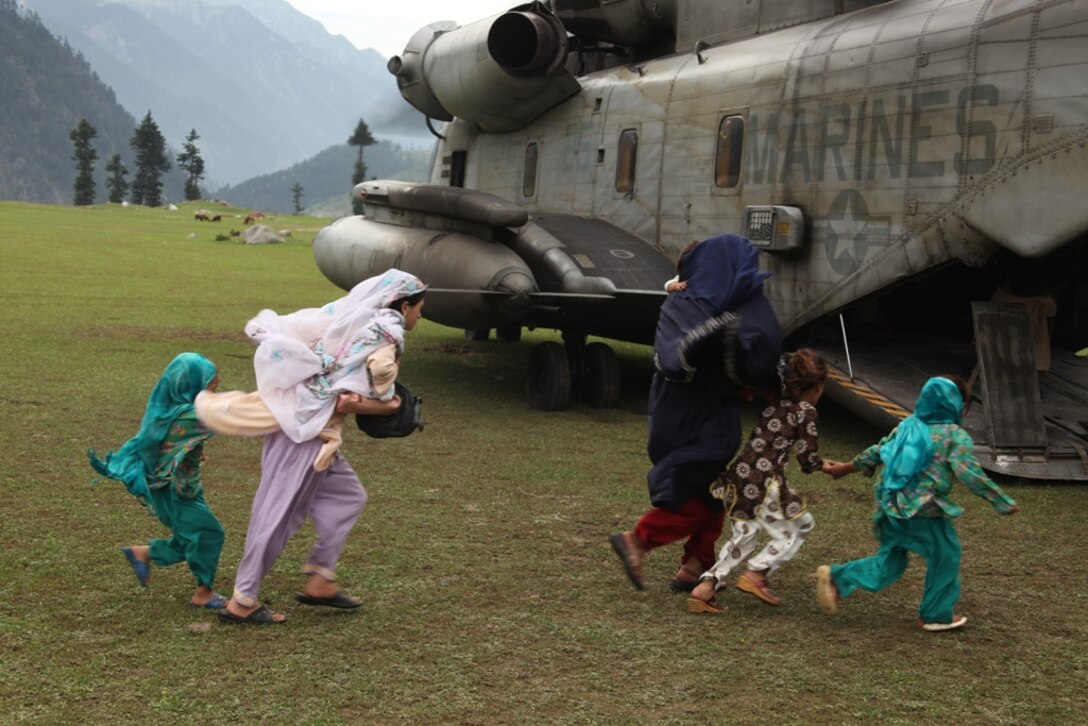 Pakistani citizens board Marine Super Stallion (CH-53E) helicopters from HMM-165 (REIN), 15th MEU during humanitarian relief efforts in the Khyber-Pakhtunkhwa province, Pakistan (formerly known as the Northwest Frontier province, Pakistan).
