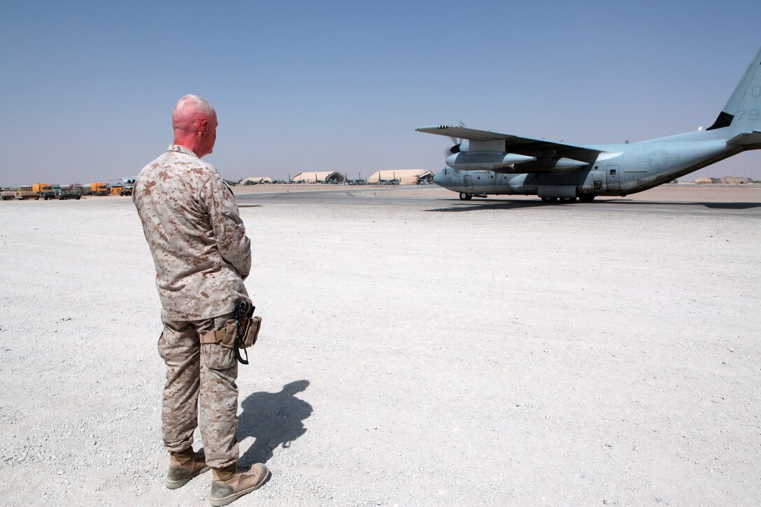 Regional Command Southwest Commander, Maj. Gen. Richard P. Mills, waits to greet the Commandant of the Marine Corps, Gen. James T. Conway, at the flight line at Camp Bastion, Aug. 18. The commandant was accompanied by the Sergeant Major of the Marine Corps Sgt. Maj. Carlton Kent during his three-day tour of southern Afghanistan Marine units.