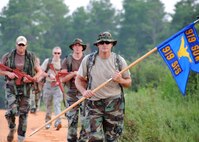 Tech. Sgt. Barry Bailey, 919th Security Forces Squadron, leads a ruck march with the squadron's guidon during the August unit training assembly at Duke Field. The squadron performed one of its quarterly six-mile-long ruck marches with each member wearing 65 pounds of gear. (U.S. Air Force photo/Tech. Sgt. Cheryl Foster)

