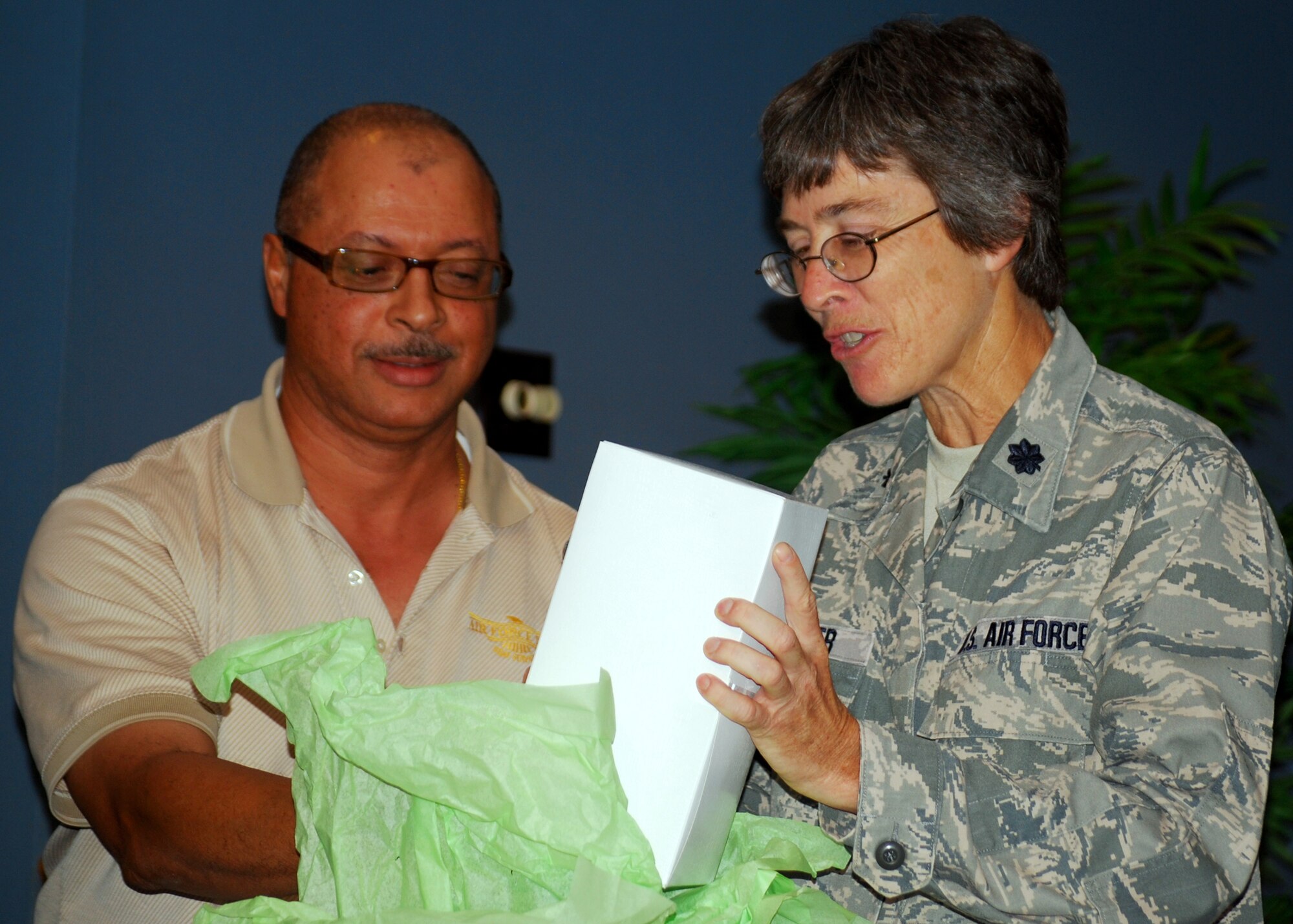 Lt. Col. Patricia Brewer, 919th Mission Support Group deputy commander, excitedly opens her parting gift from Myron Webb, Duke Field Lodging. The 919th Special Operations Wing held a going-away ceremony for her during the August unit training assembly. Colonel Brewer moves on to Beale AFB, Calif. in September. (U.S. Air Force photo/Tech. Sgt. Cheryl Foster)
