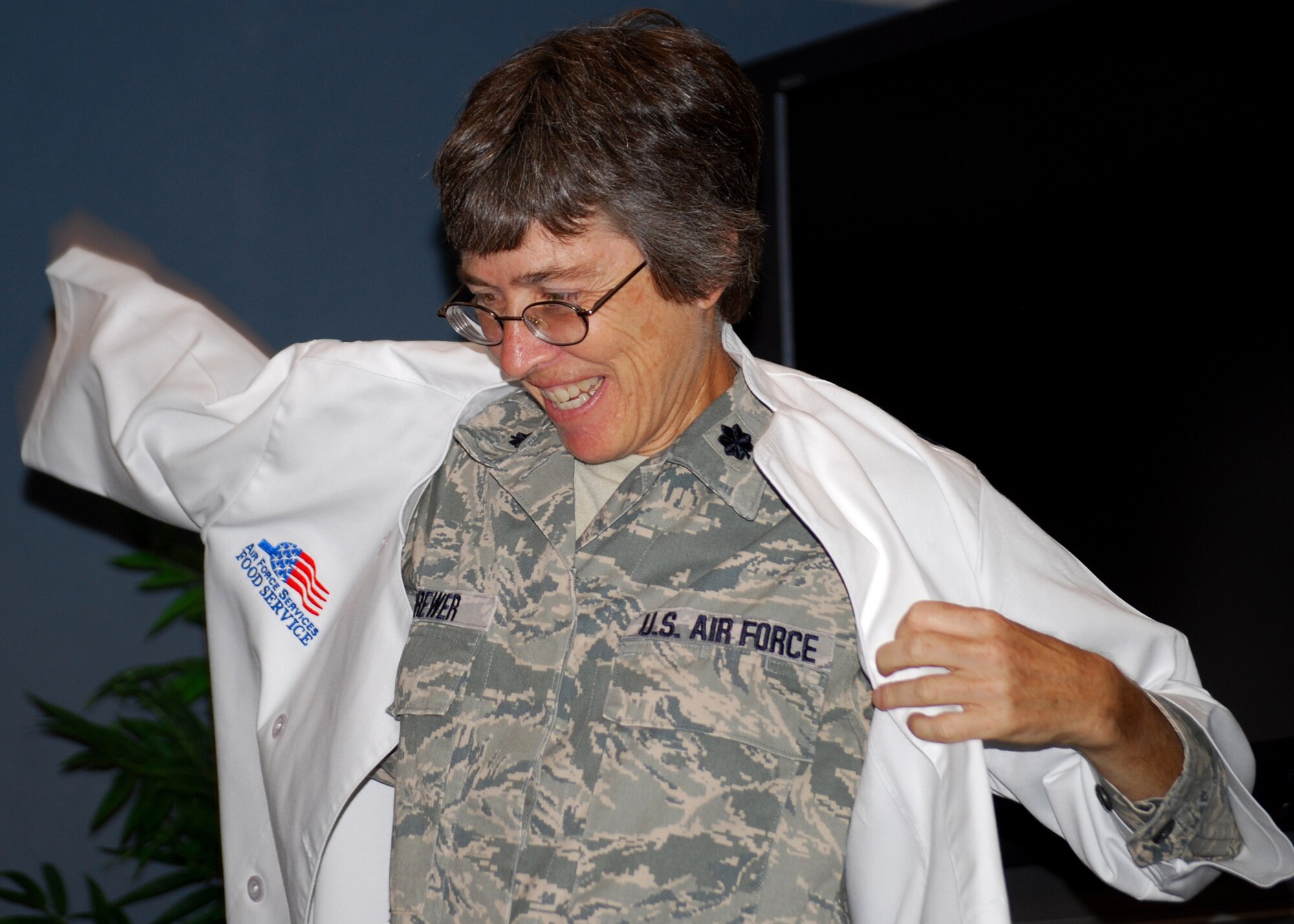 Lt. Col. Patricia Brewer, 919th Mission Support Group deputy commander, tries on her
parting gift from the 919th Services Flight, her very own chef coat. The 919th Special Operations Wing held a going-away ceremony for her during the August unit training assembly. Colonel Brewer moves on to Beale AFB, Calif. in September. (U.S. Air Force photo/Tech. Sgt. Cheryl Foster)
