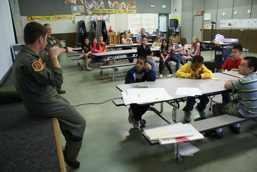 Capt. John Miranda and Capt. Emily Yturralde, 10th Airlift Squadron pilots at Joint Base Lewis-McChord, Wash., speak to a class of fifth grade students at Delong Elementary School in Tacoma, Wash., on Aug. 18, 2010. The fifth graders, currently in summer science camp, learned about the principles of flight and what it takes to become a pilot.(U.S. Air Force Photo/Airman Leah Young) 