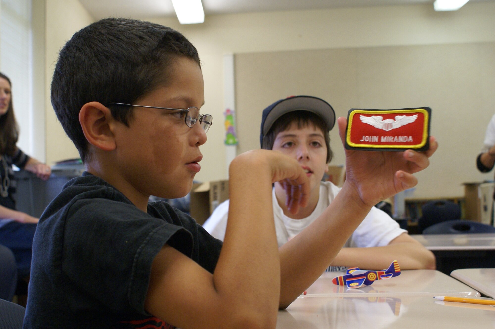 Fifth grade students at Skyline Elementary School study a pilot's name patch during a series of Tacoma elementary school visits Aug. 18. Pilots assigned to Joint Base Lewis-McChord visited Tacoma elementary schools to speak about the principles of flight and what it takes to become a pilot. (U.S. Air Force Photo/Airman Leah Young)
