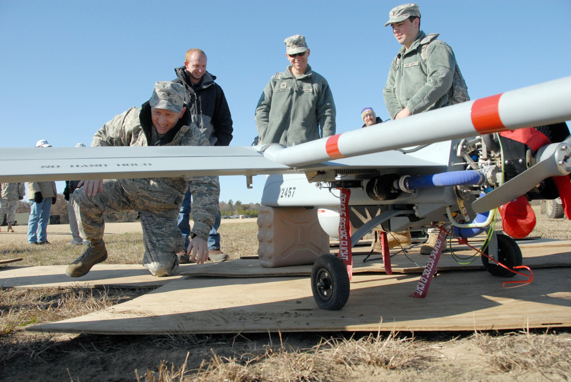 Brig. Gen. Don Dunbar, adjutant general of Wisconsin, enjoys a close inspection of the RQ-7 Shadow 200 unmanned aerial vehicle during a training exercise Nov. 2, 2009 at Fort McCoy. The 22-person UAV platoon, part of Company B, Brigade Special Troops Battalion, 32nd Infantry Brigade Combat Team, includes UAV pilots, camera operators, maintainers and support crew. The platoon will operate out of Volk Field, where a new $8 million facility is planned. Wisconsin National Guard photo by 1st Sgt. Vaughn R. Larson
