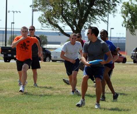 Team McConnell Airmen compete in a game of Ultimate Frisbee during a Boss N’ Buddy’s “Grill Your Own Steak” event at the Robert J. Dole Community Center Aug. 18, 2010, McConnell Air Force Base, Kan. During each month’s Boss N’ Buddy gathering, private organizations on base may compete in sports tournaments. This is an opportunity for Airmen to socialize and intermingle with base leadership.  (U.S. Air Force photo/Airman 1st Class Andrea Salazar)
