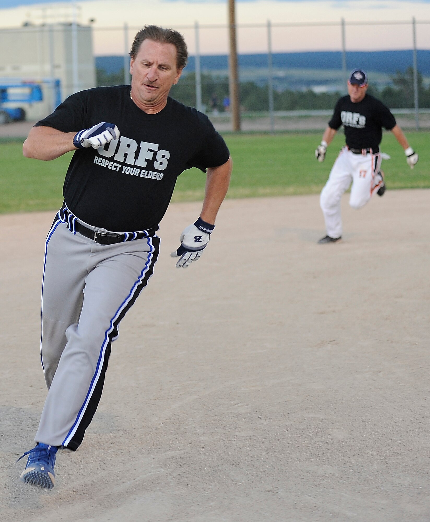 Ken Zito, foreground, and Steve Hudson round the bases during the Retirees' softball championship match against the Med Group Aug. 11, 2010. The Retirees carried the day, 29-19, to win their second championship in three years. (U.S. Air Force photo/Rachel Boettcher)