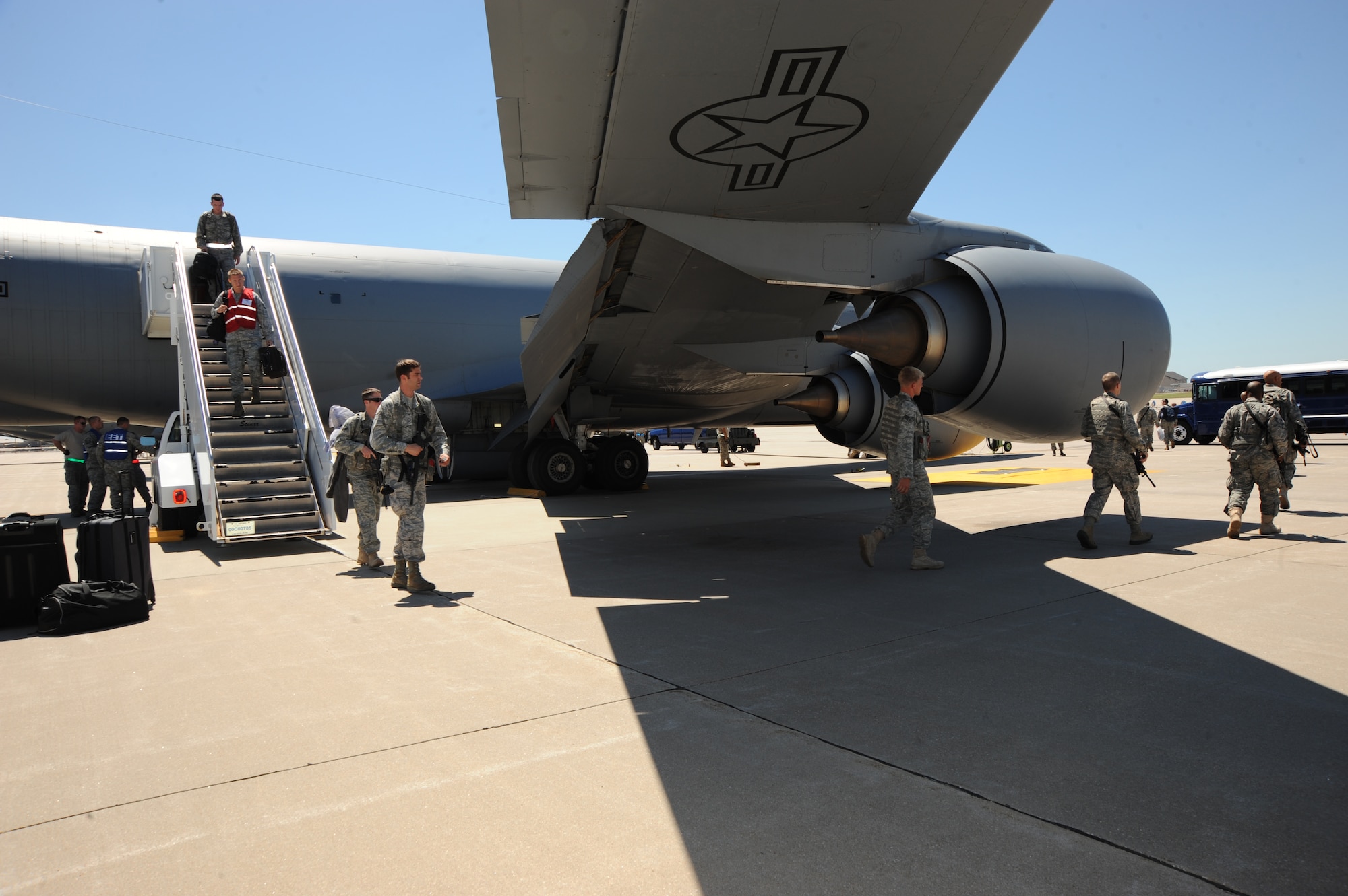 Team McConnell Airmen depart a KC-135 Stratotanker during an operational readiness exercise Aug. 18, 2010, McConnell Air Force Base, Kan.  More than 100 Airmen deployed to an Air Force base in the United States during an exercise to test the base’s ability to provide rapid mobility and air refueling support.  (U.S. Air Force photo/Airman 1st Class Andrea Salazar)