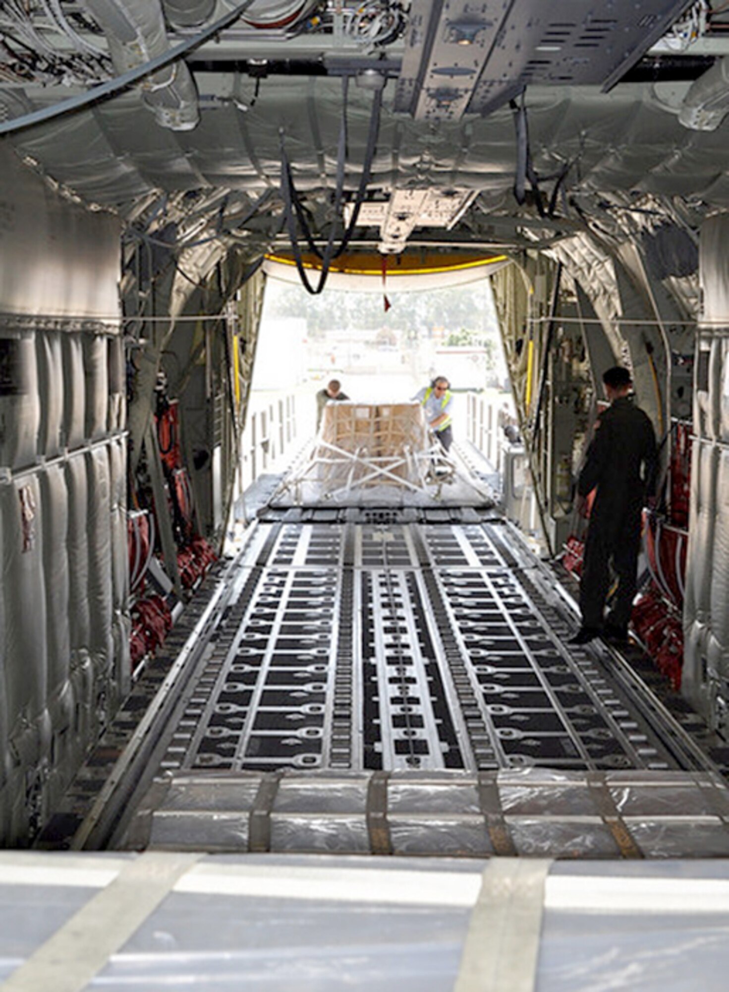 Senior Airman Steve Baird III and a Spanish employee from InterJet, load a pallet of firefighting equipment onto a C-130J Super Hercules Aug. 12, 2010, at Naval Station Rota, Spain. NAVSTA Rota sent nearly $20,000 of equipment to help Russia control and extinguish wildfires, save lives, homes, infrastructure, and natural resources. Airman Baird is a loadmaster from the 37th Airlift Squadron at Ramstein Air Base, Germany. (U.S. Navy photo/Petty Officer 1st Class Paul Cage)